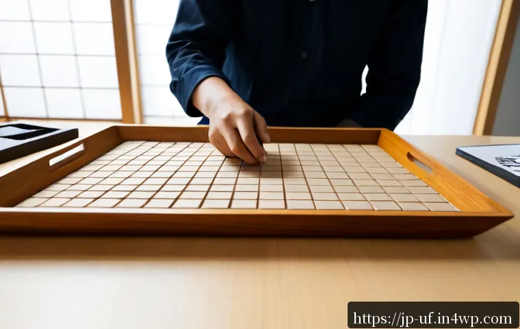 제약 기반 창의성의 혁신적 접근 방법 - Photorealistic Japanese product designer in a calm modern Tokyo studio, arranging simple geometric m...